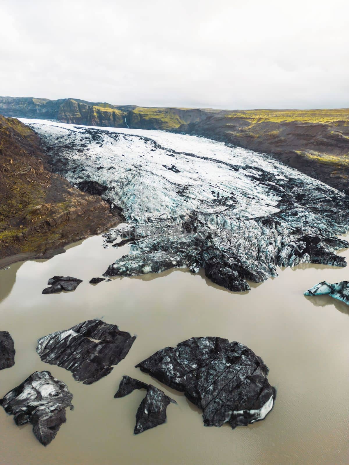 Beautiful Aerial view of the massive Svinafellsjokull Glacier in Iceland and its lagoon caused by global warming. High quality photo