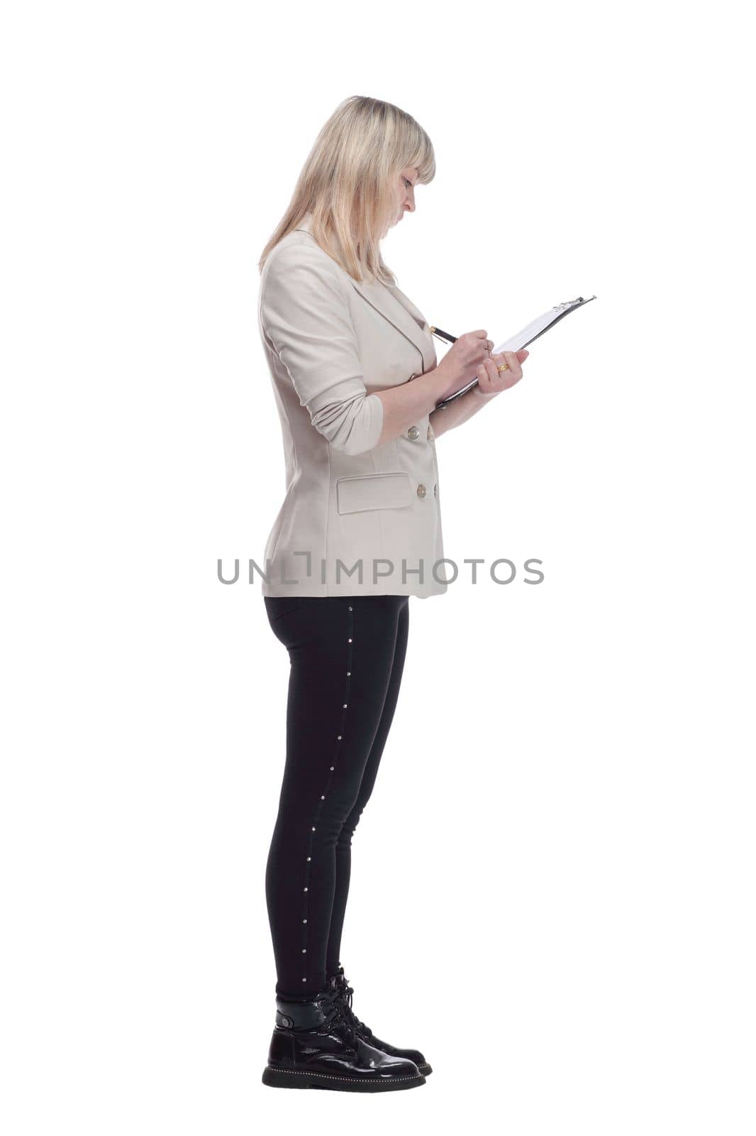 side view. Mature blonde woman writing something to the clipboard . isolated on a white background.