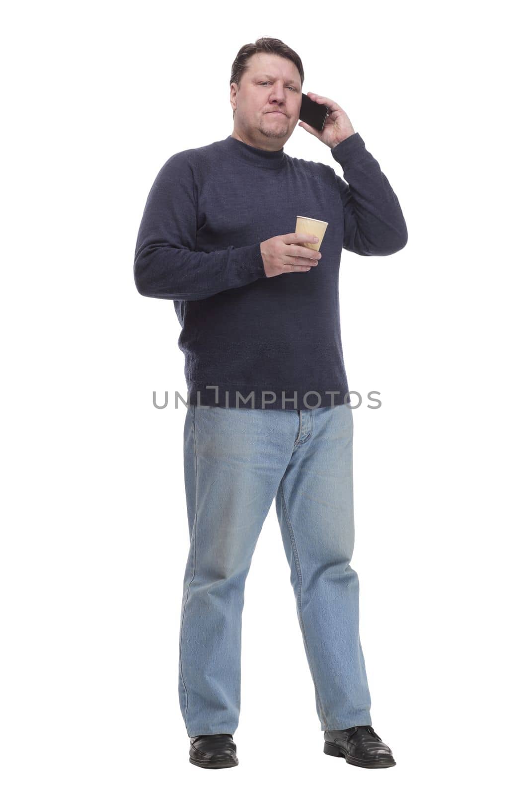 casual mature man with smartphone and takeaway coffee .isolated on a white background.