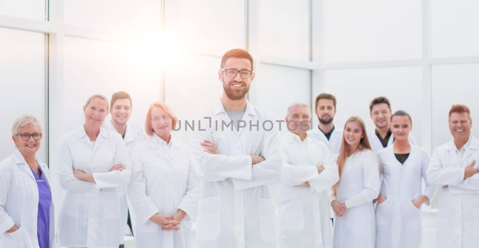 smiling research supervisor standing in front of his team. concept of health protection.