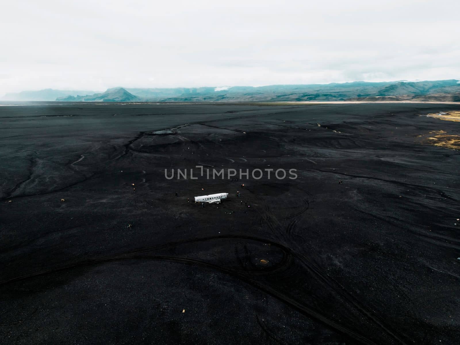 Crashed military plane in black sand Solheimasandur beach. The US Navy DC-3 super bus airplane crash landed in Iceland. Solheimasandur beach, close to town Vik. High quality photo