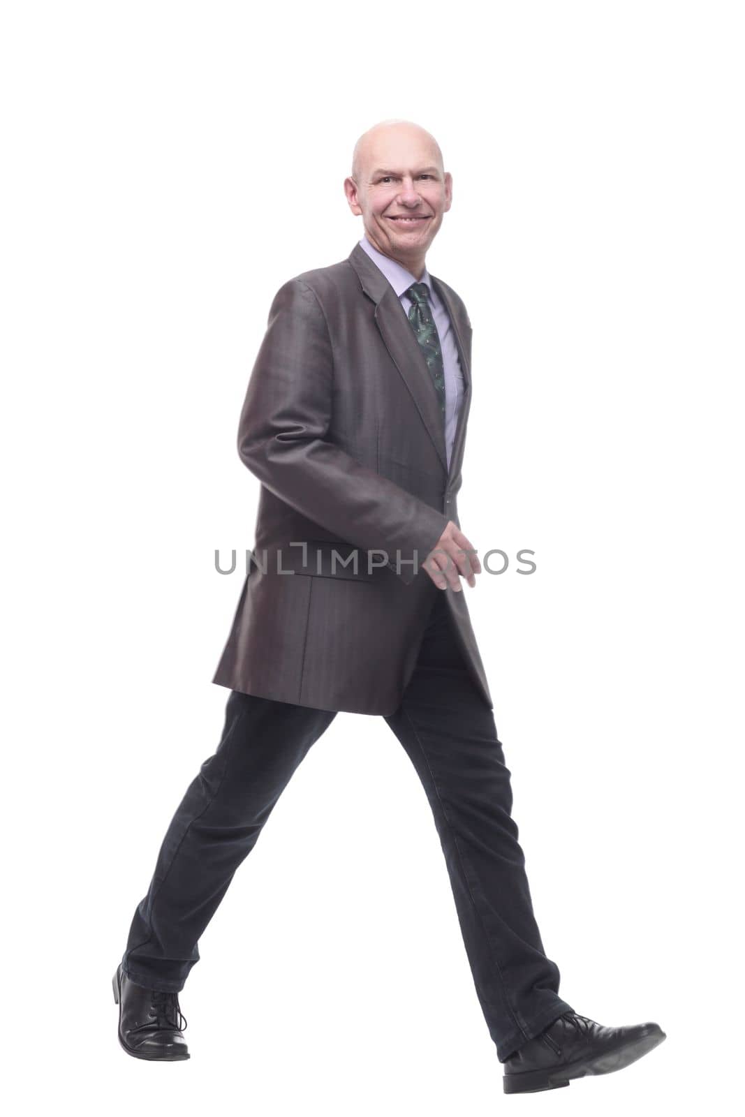 in full growth. Executive business man striding forward . isolated on a white background.