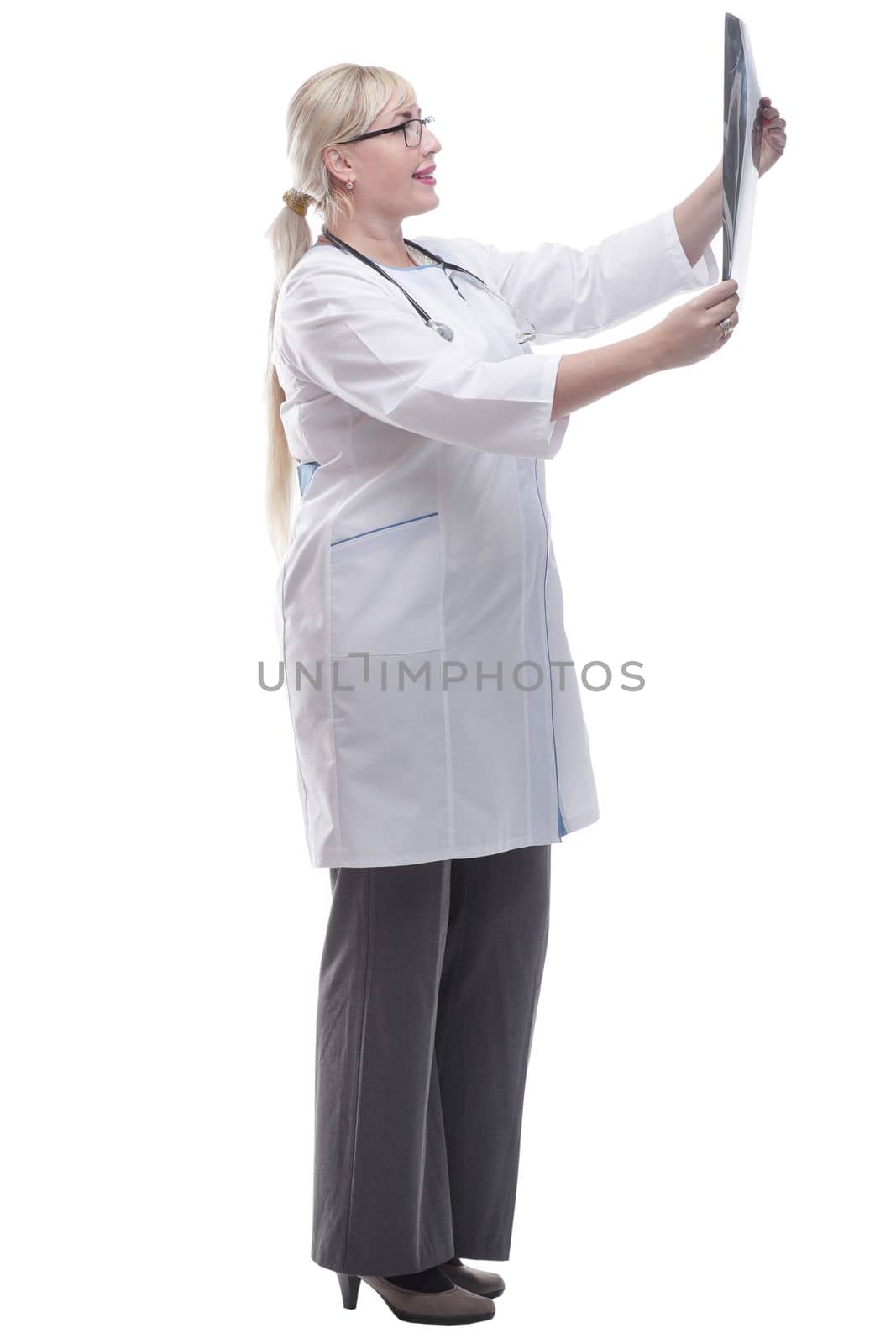 in full growth. smiling woman doctor looking at an x- ray. isolated on a white background