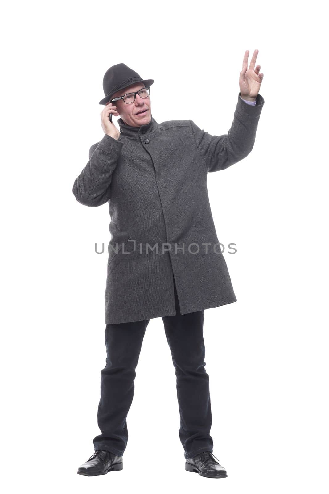 in full growth. intelligent man with a smartphone. isolated on a white background.
