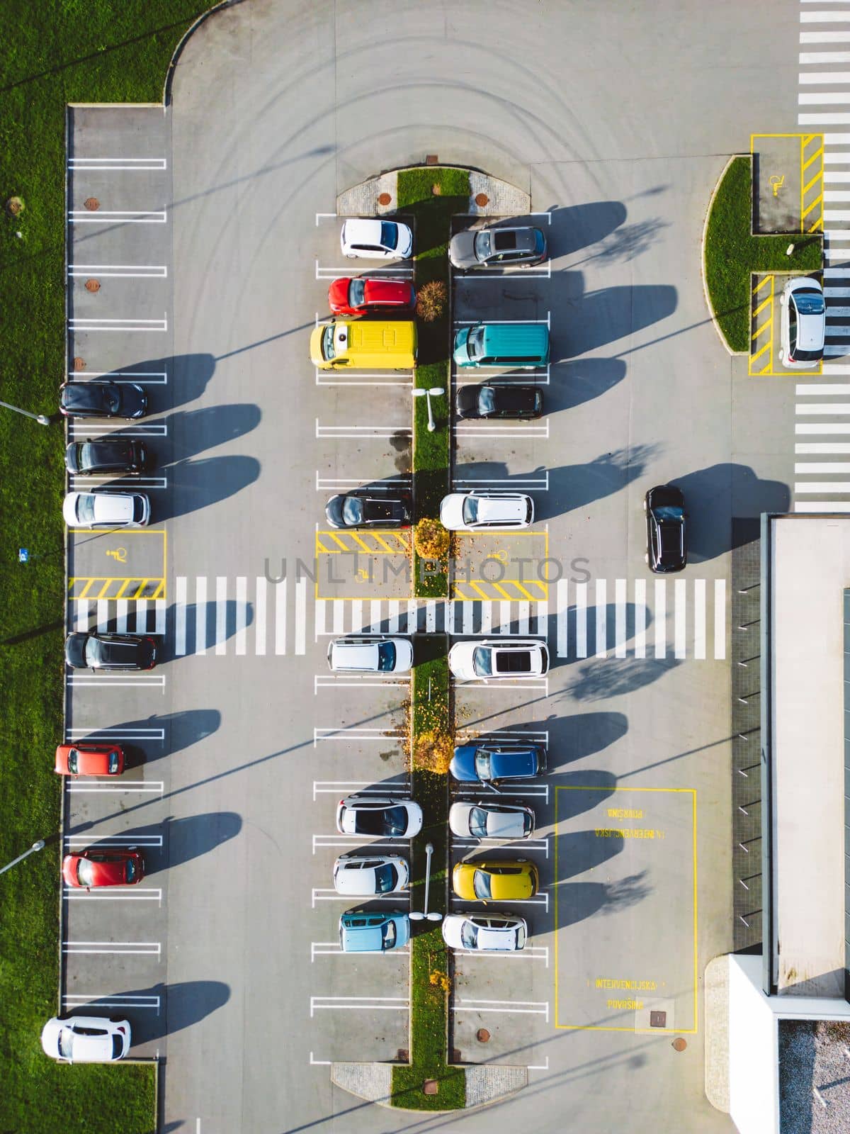 Aerial view of industrial building with a large parking lot somewhere in the countryside of Slovenia.