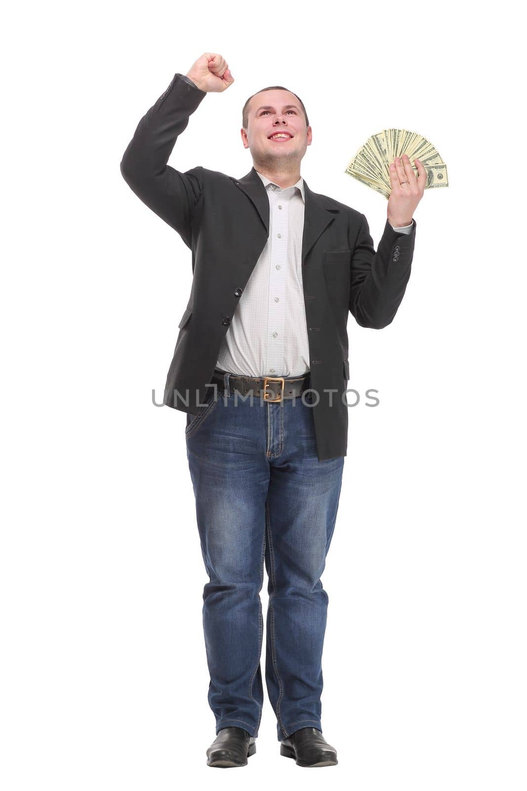 Happy young man holding money while standing and arm up, isolated on white background