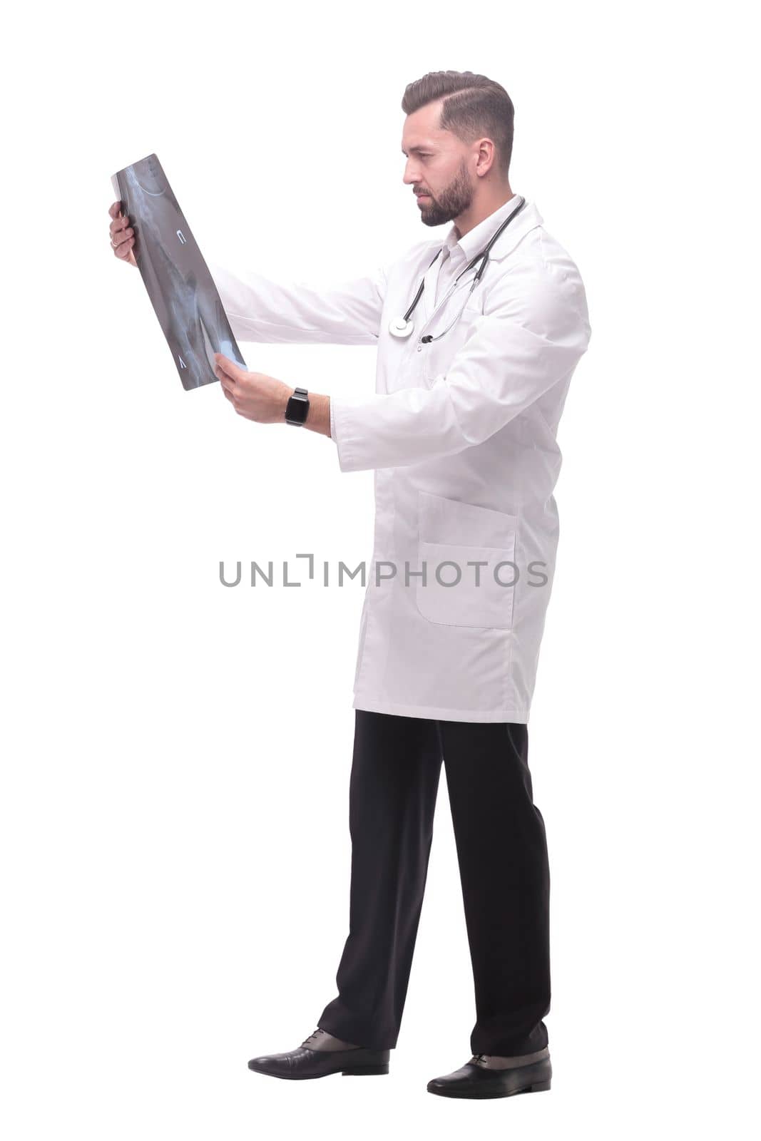 in full growth. medical doctor looking closely at the x-ray . isolated on white background