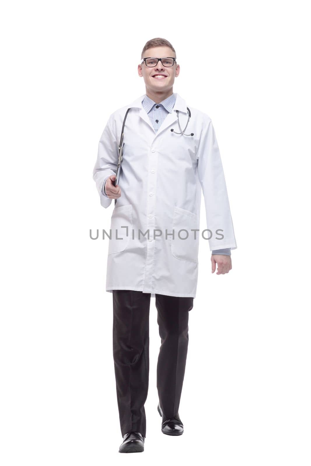 in full growth. young doctor with a clipboard. isolated on a white background.