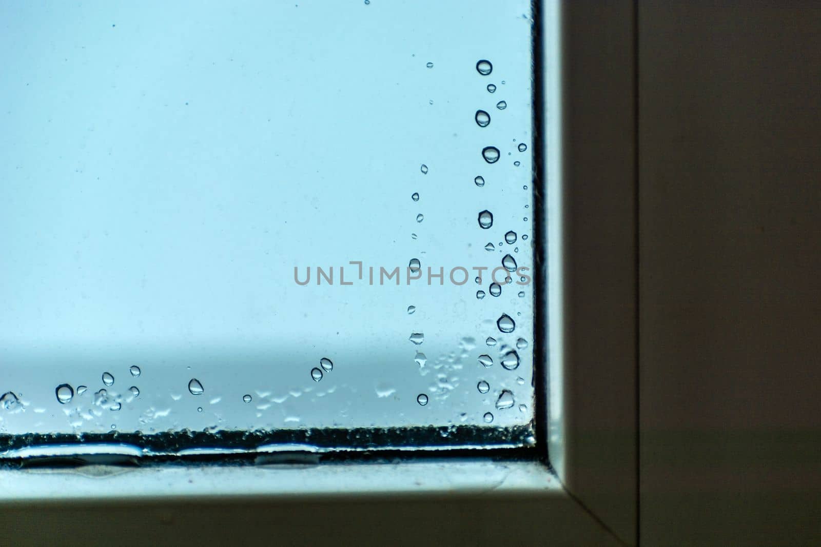 Drops of water on the glass in the corner of the window by darekb22