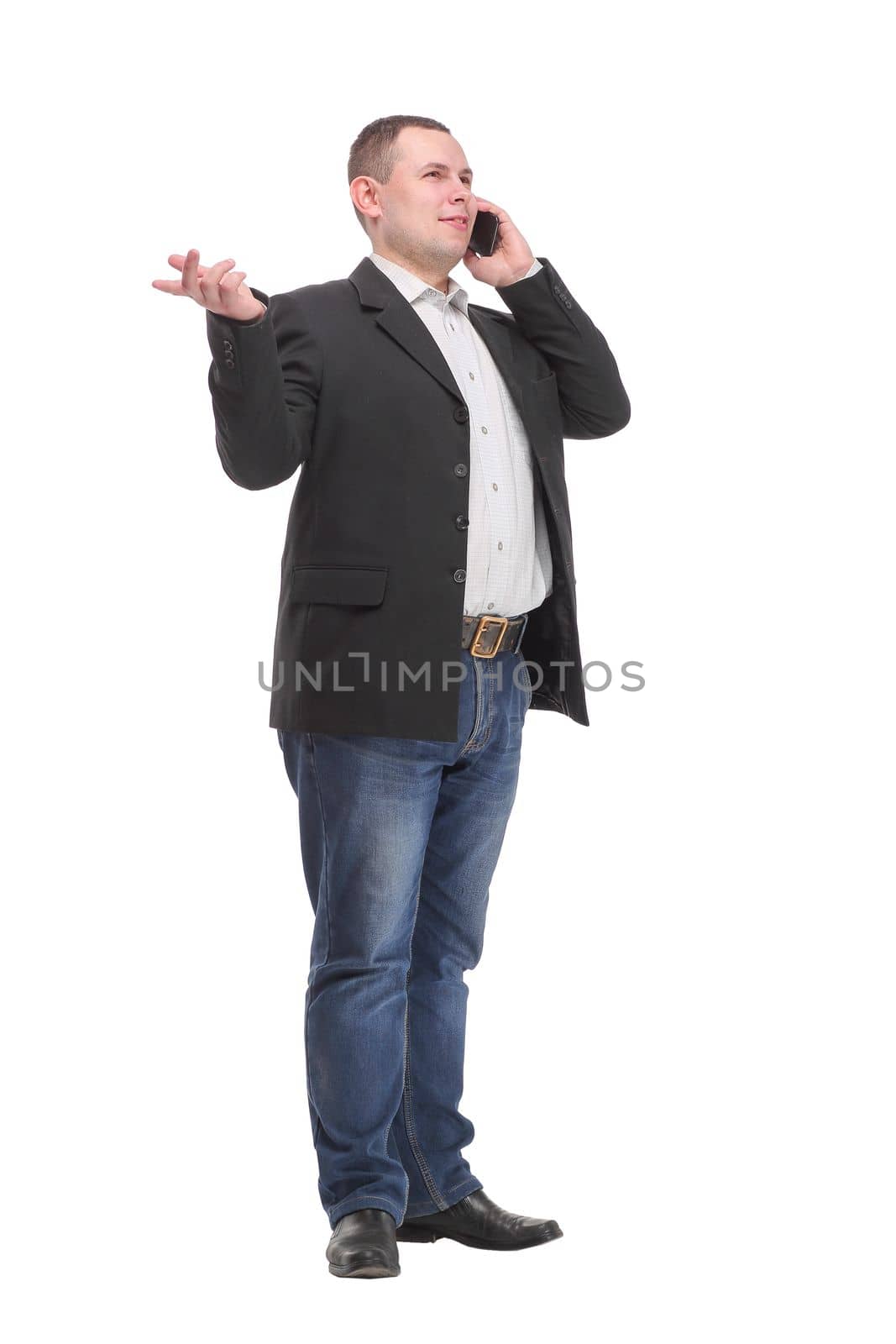 Full-length portrait of a happy businessman talking on the phone over white background