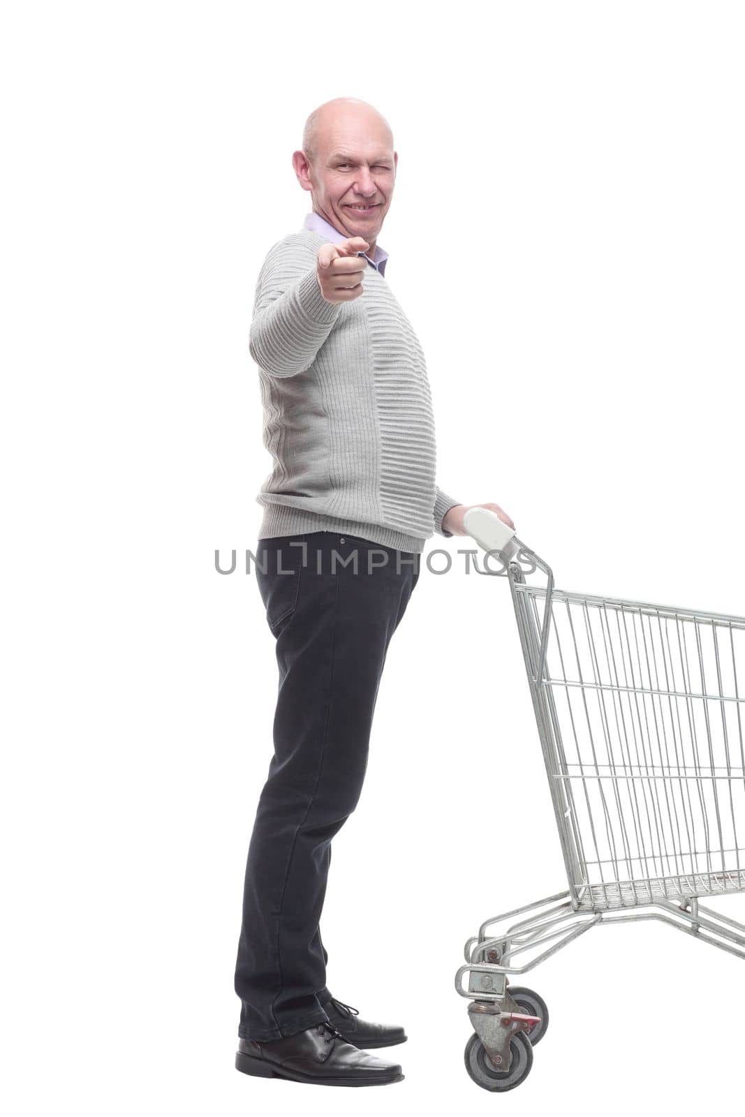 in full growth. a happy man with a shopping cart. isolated on a white background.