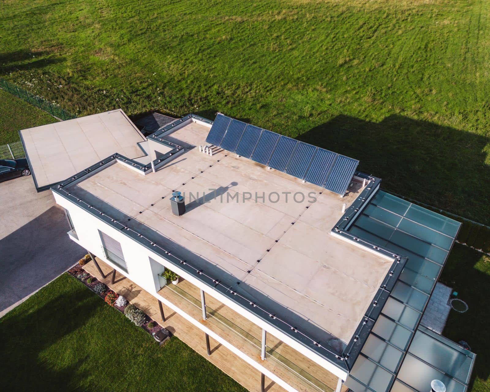 Modern family home, view from the air with solar panels on the roof top by VisualProductions