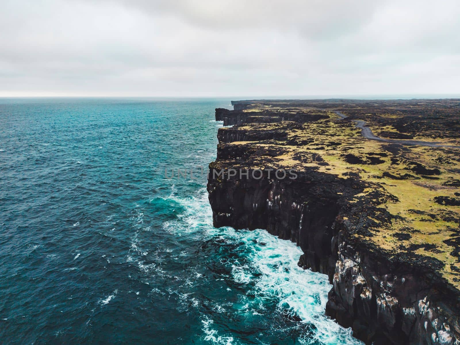 View of the sea in West Iceland highlands, Snaefellsnes peninsula, View Point near Svortuloft Lighthouse. Spectacular black volcanic rocky ocean coast with cave arch and towers. High quality photo