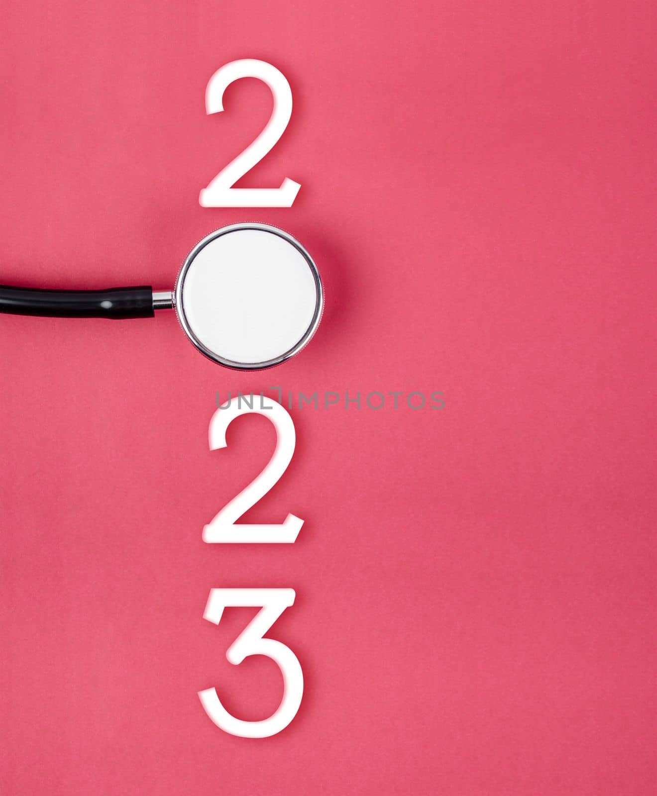 The stethoscope with number 2023 on red background. Happy new year for health care and calendar cover by Gamjai
