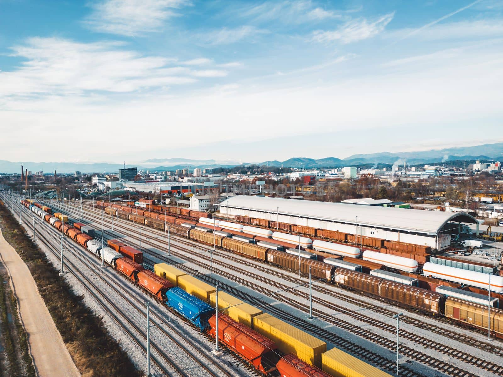 Cargo trains close-up. Aerial view of colorful freight trains on the railway station. Wagons with goods on railroad. Heavy industry. Industrial conceptual scene with trains. Top view from flying drone. High quality photo