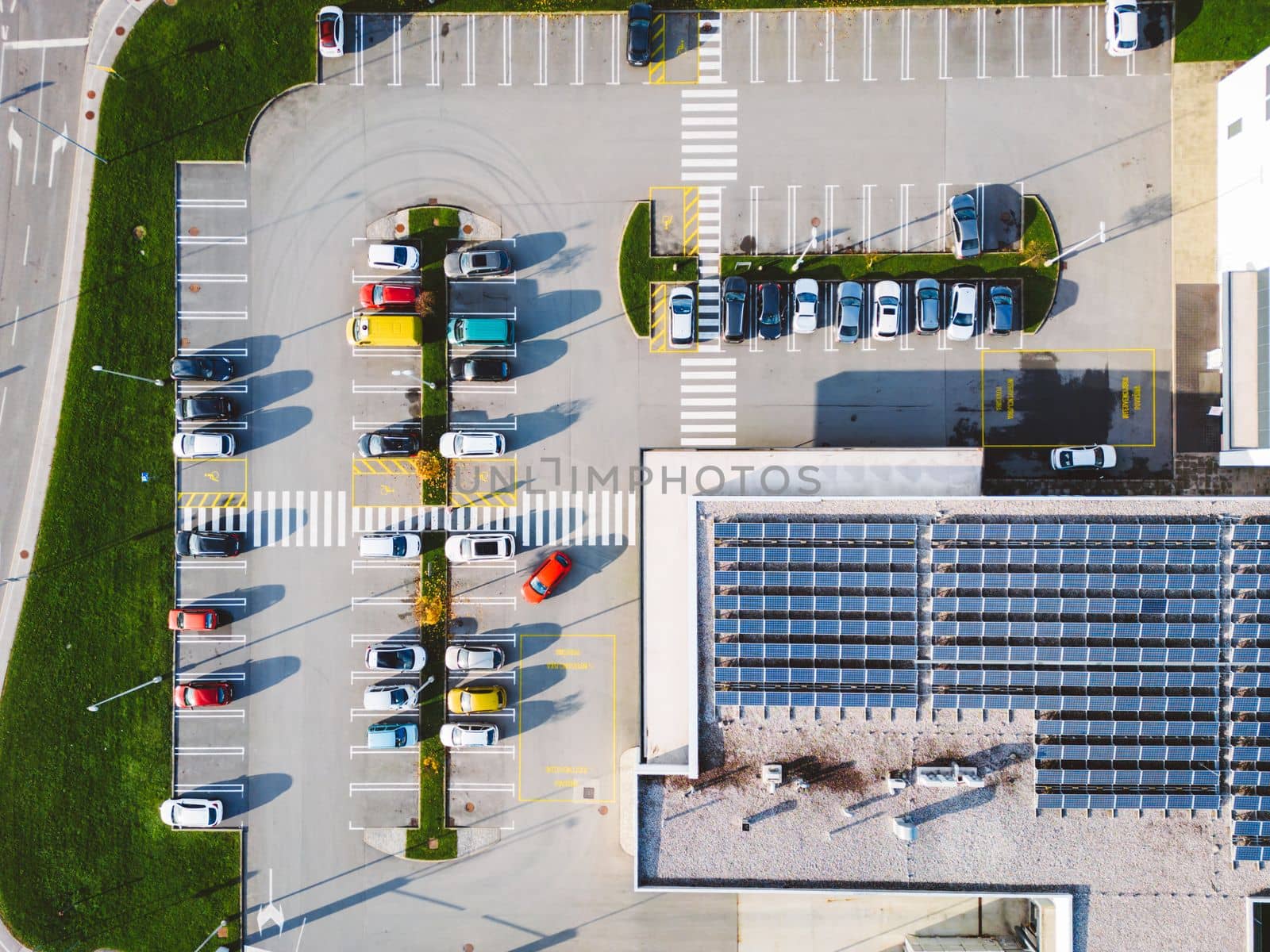 Aerial view of industrial building with a large parking lot somewhere in the countryside of Slovenia.