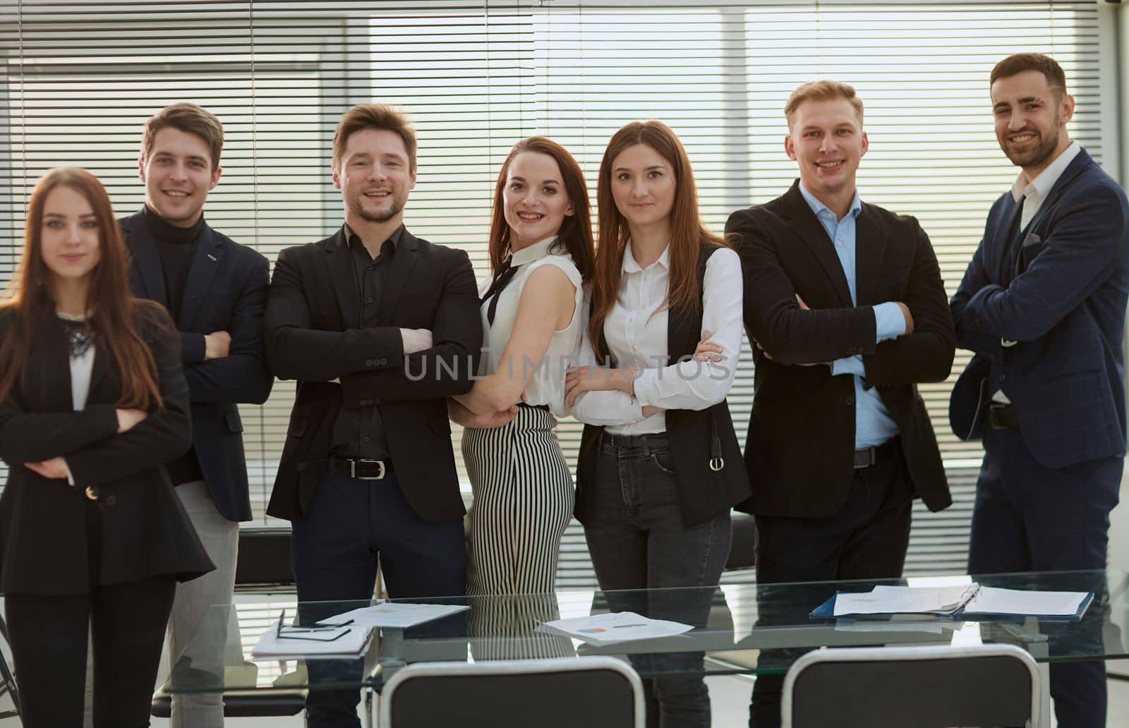 group of confident young employees standing in the office. concept of professionalism.