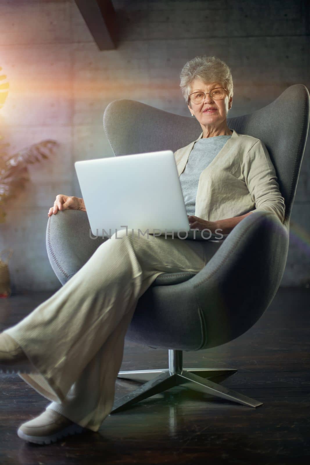 woman sitting in a chair in Art Nouveau style. Business, elegant businesswoman working on laptop . Interior, furniture.