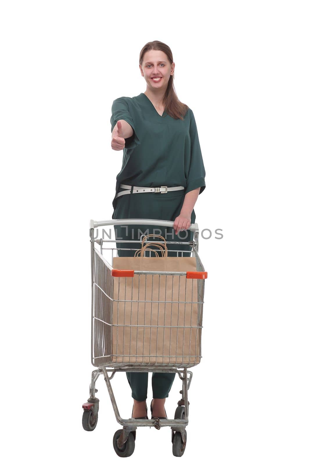 Full length portrait of a woman pushing a shopping trolley isolated on white background