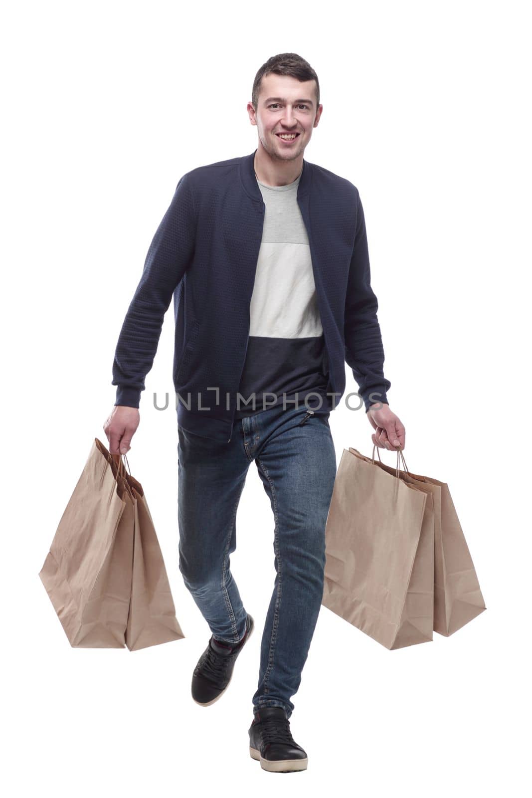 young man with shopping bags striding forward . isolated on a white background.