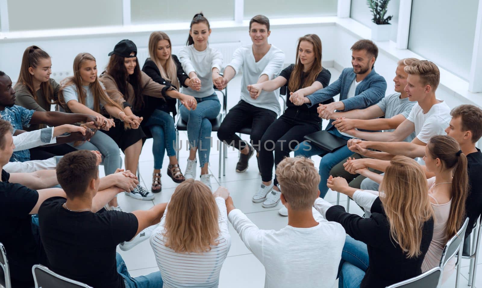 group of young like-minded people holding each other's hands. business and education