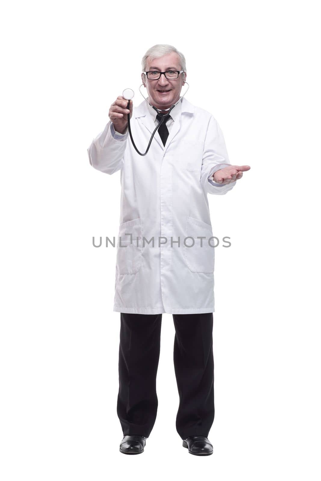 in full growth.friendly mature doctor with a stethoscope in hand. isolated on a white background.