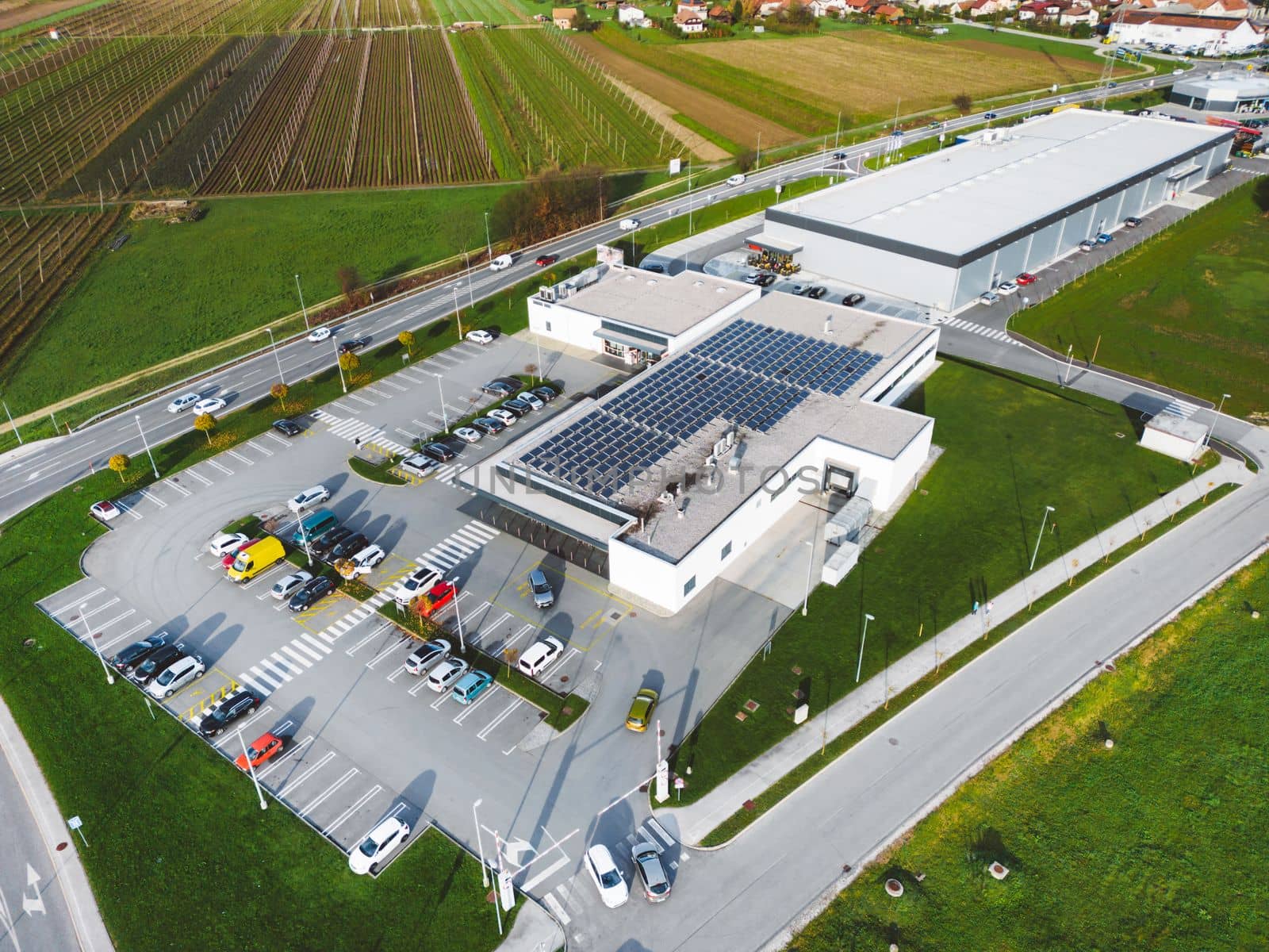 Aerial view of industrial building with a large parking lot somewhere in the countryside of Slovenia. 