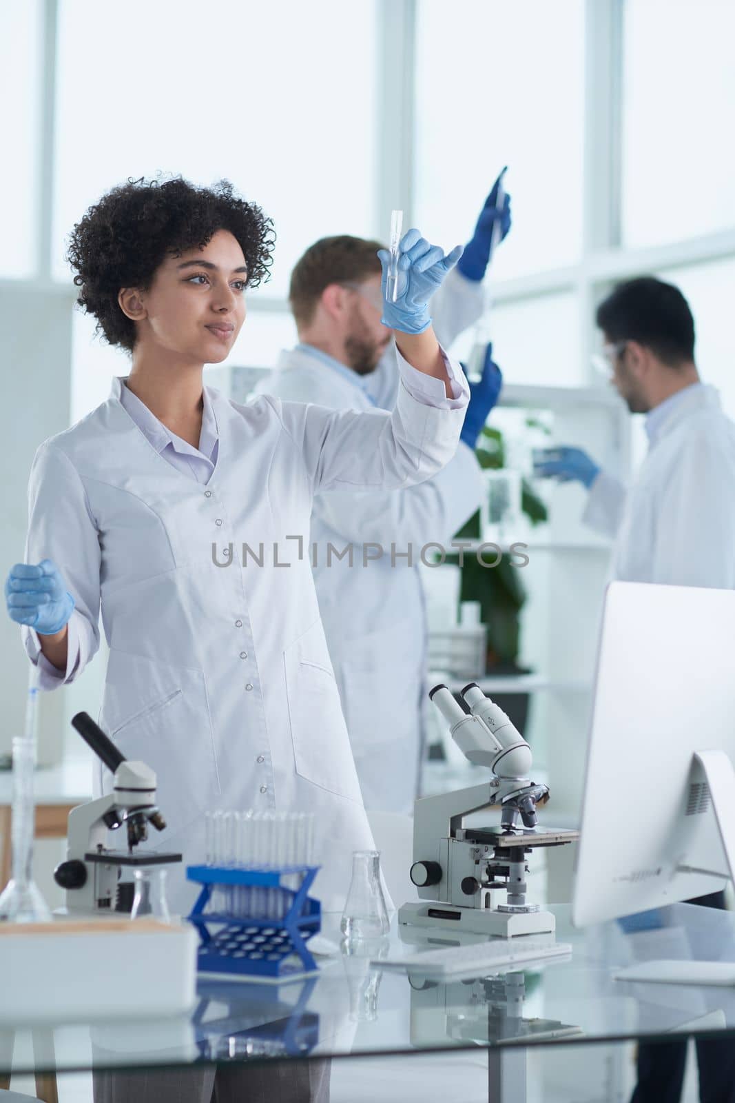 Team of Scientists Working Using Microscope, Analysing Microbiology Samples