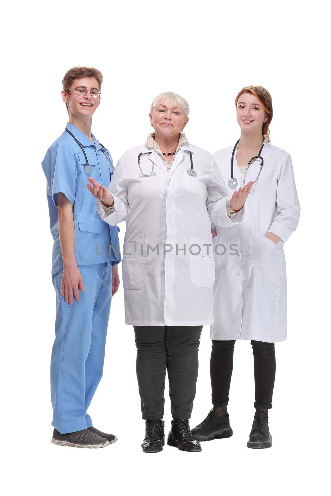 Portrait of a female doctor with two of her co-workers against white background showing welcome gesture