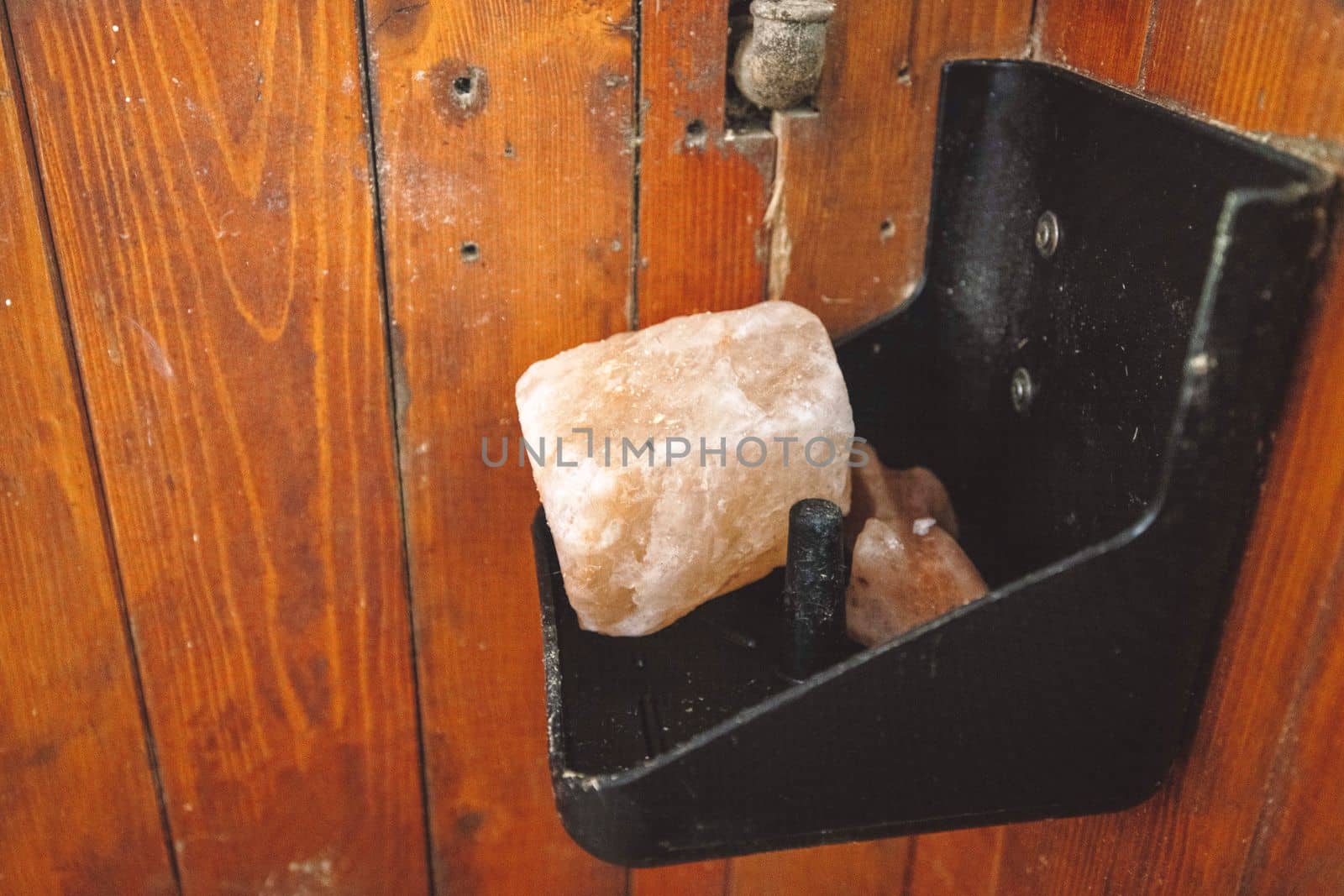 Rock salt for the horse to lick inside the horse stable on a shelf. 