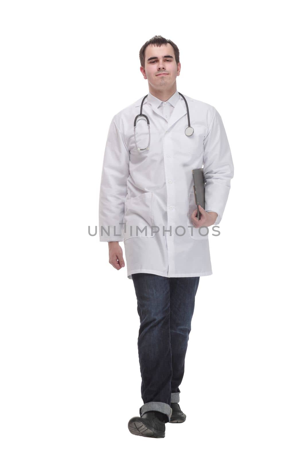 Side view of cheerful mature doctor looking at camera and smiling with clipboard, standing against white background