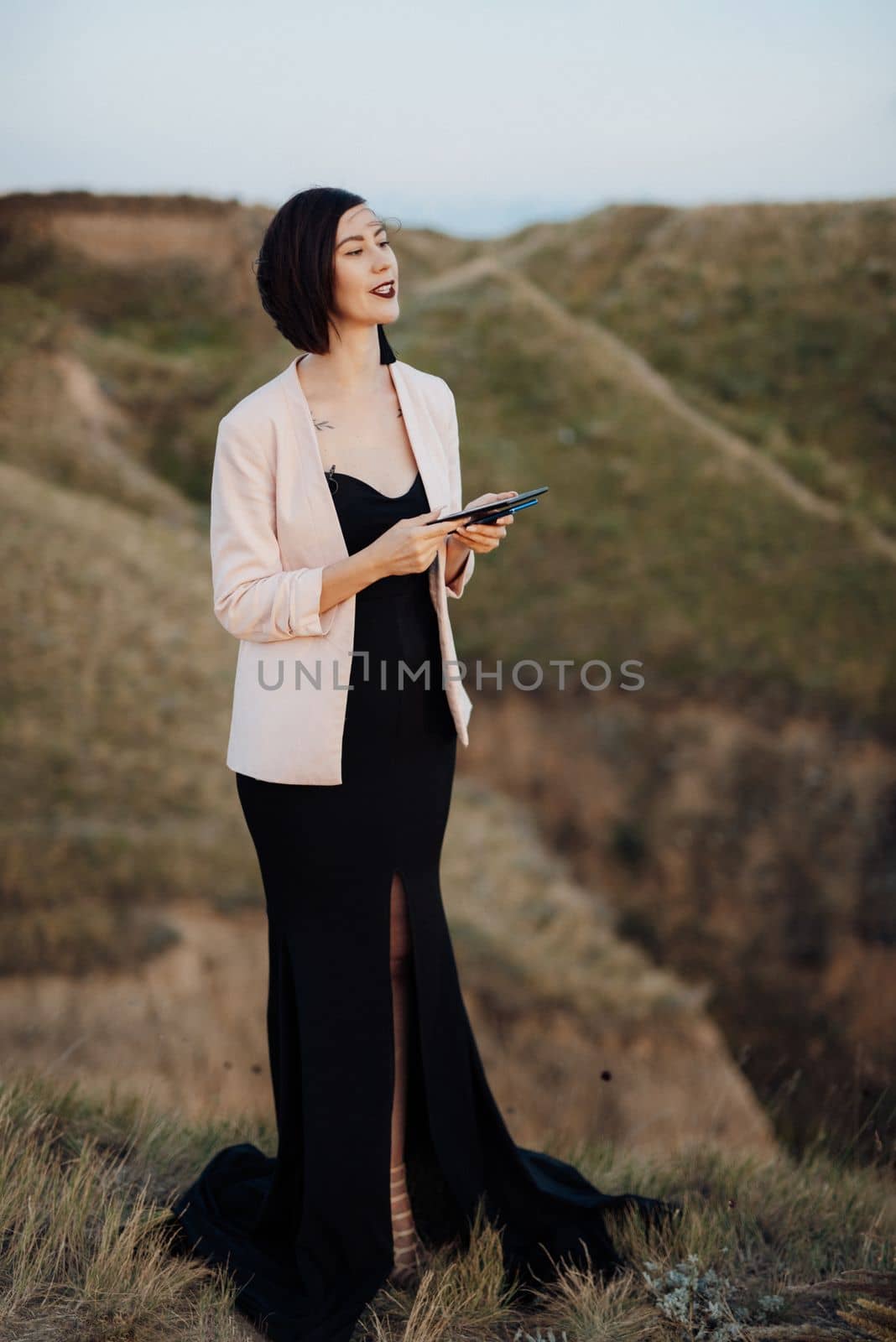 girl leading master of ceremonies on high hills near the sea