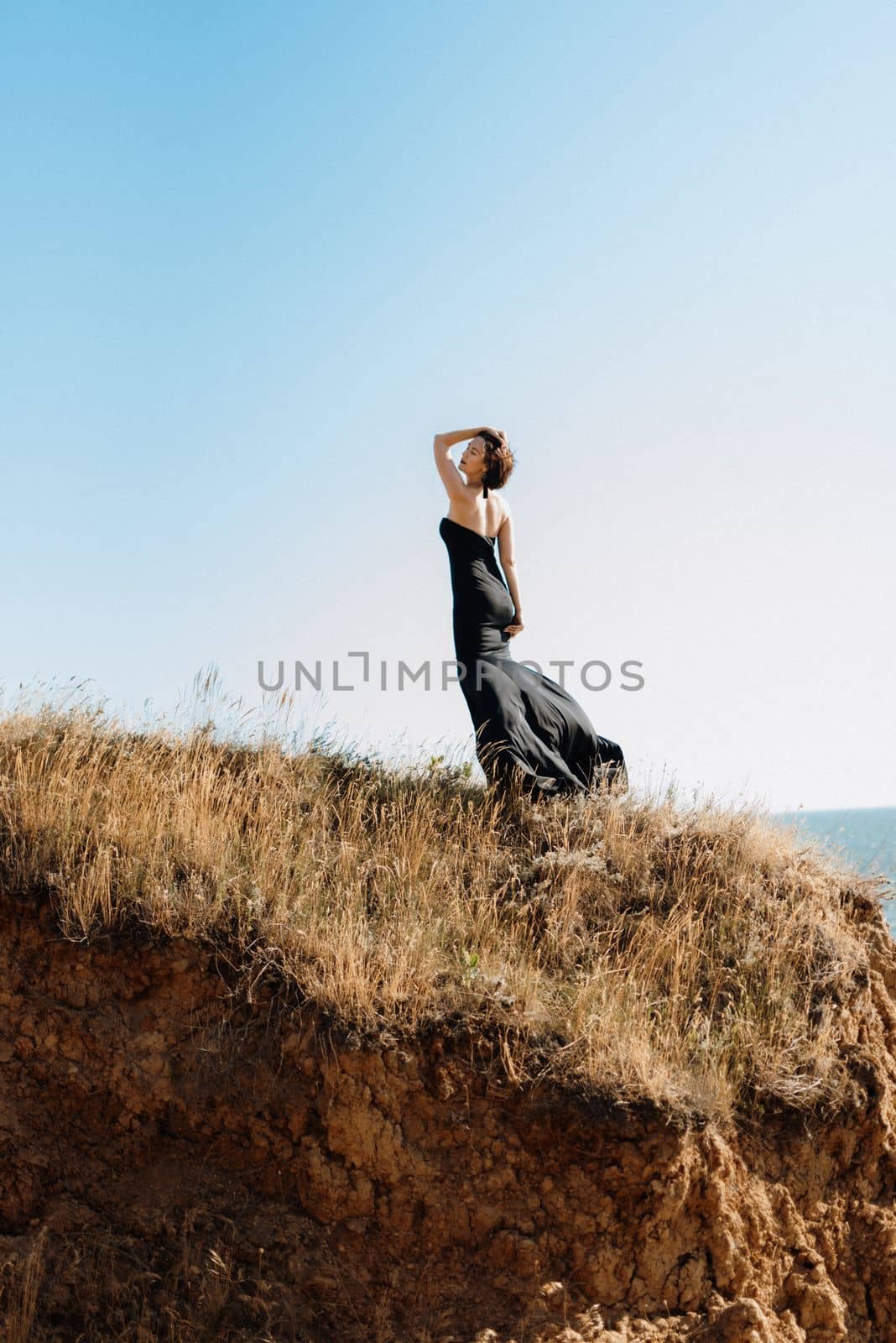 tall girl model in a black dress on the mountain hills by Andreua