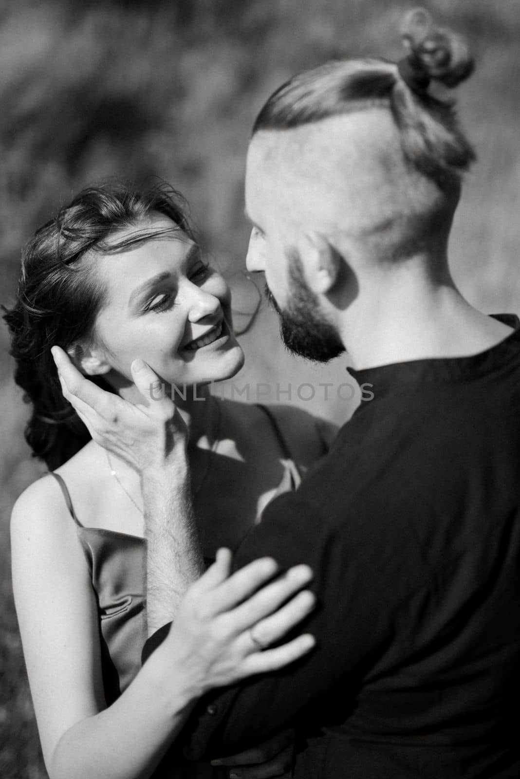 pregnant girl and boyfriend on high hills near the sea