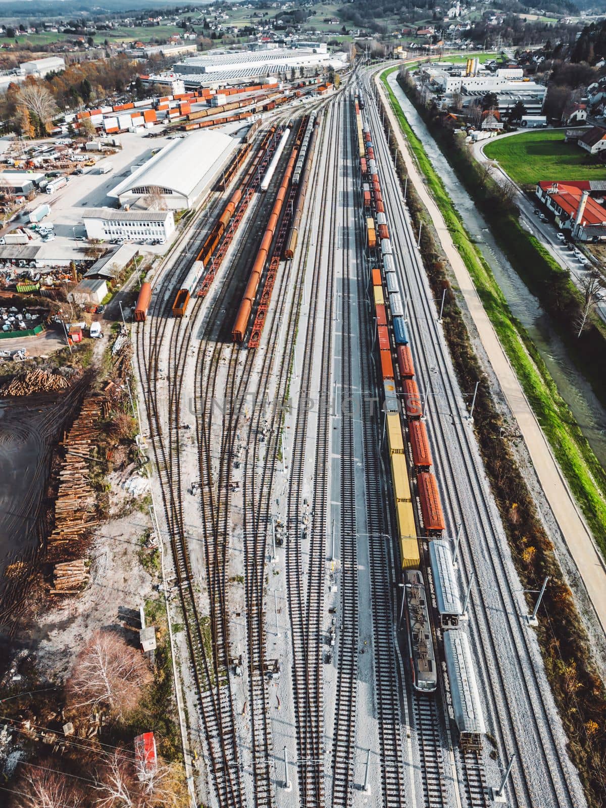Cargo trains close-up. Aerial view of colorful freight trains on the railway station. Wagons with goods on railroad. Heavy industry. Industrial conceptual scene with trains. Top view from flying drone. High quality photo