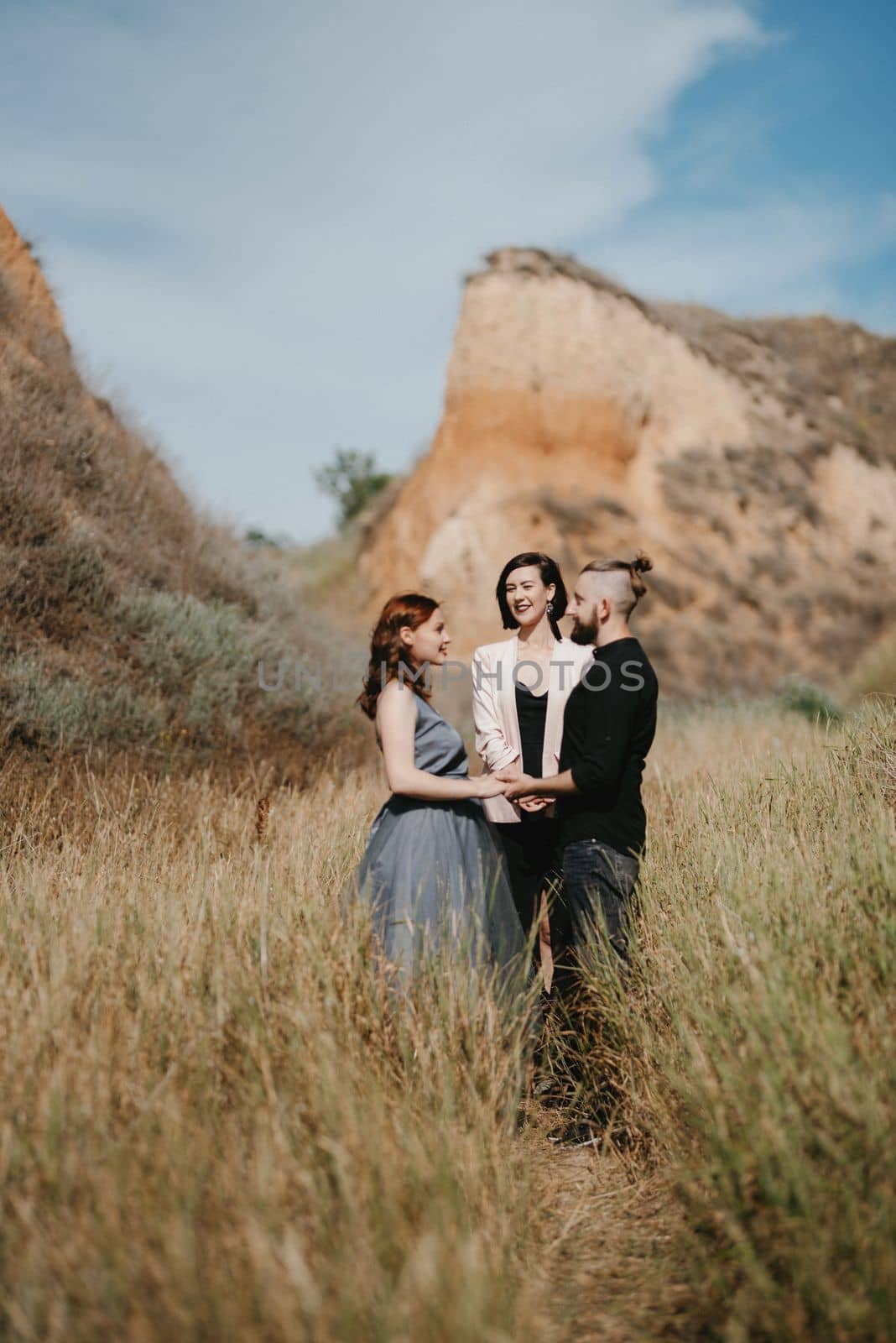 wedding ceremony of a girl and a guy on high hills near the sea