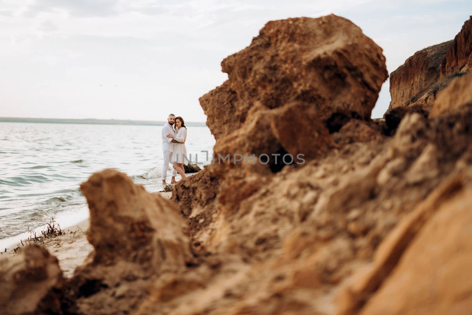 a guy with a girl in white clothes on the seashore by Andreua