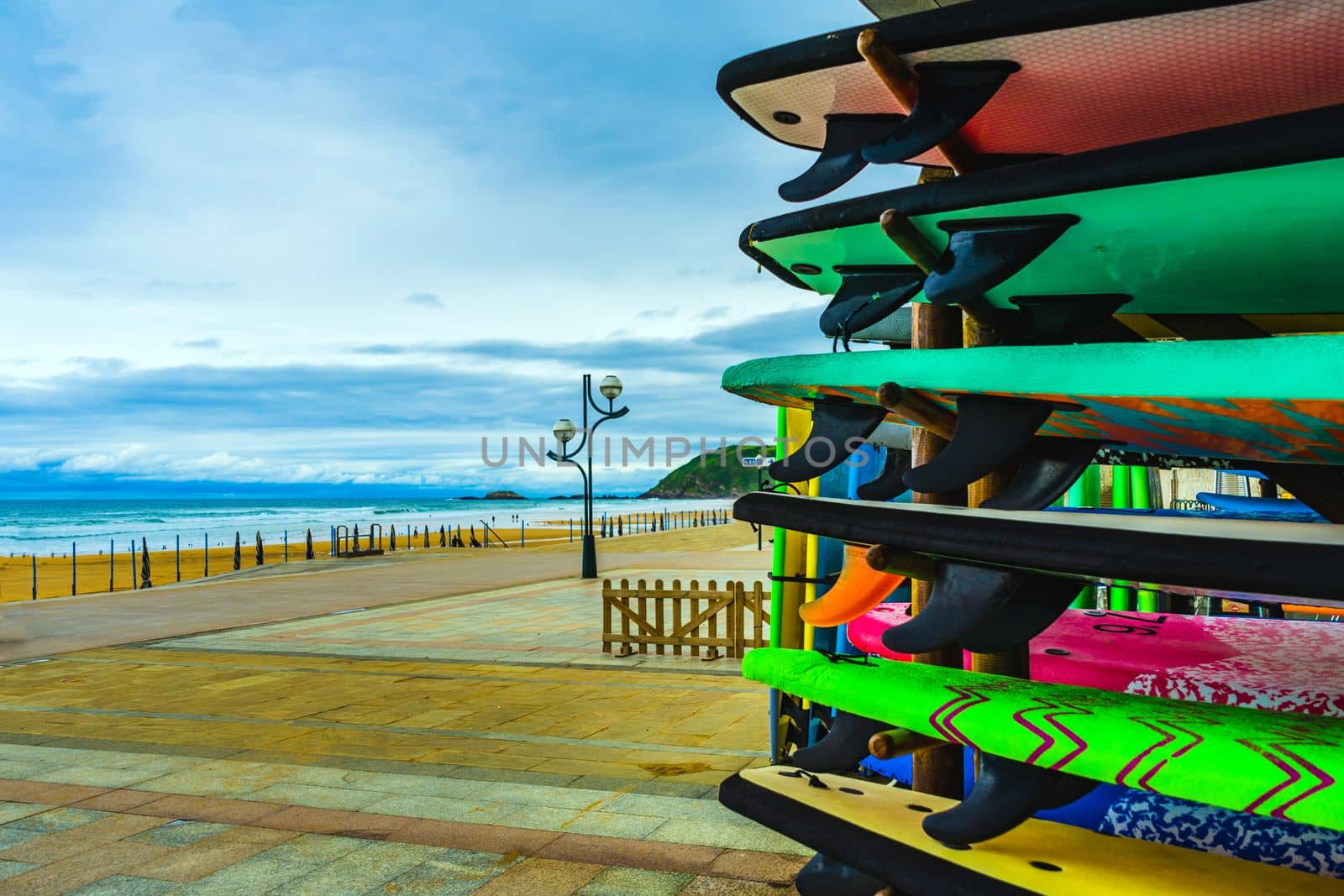 Surfboards on the background of the Atlantic coast of Spain. Surfboard rental. by paca-waca
