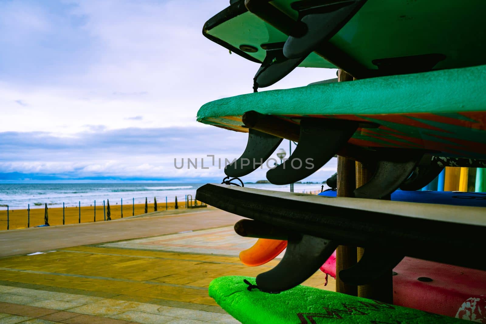 Surfboards on the background of the Atlantic coast of Spain. Surfboard rental