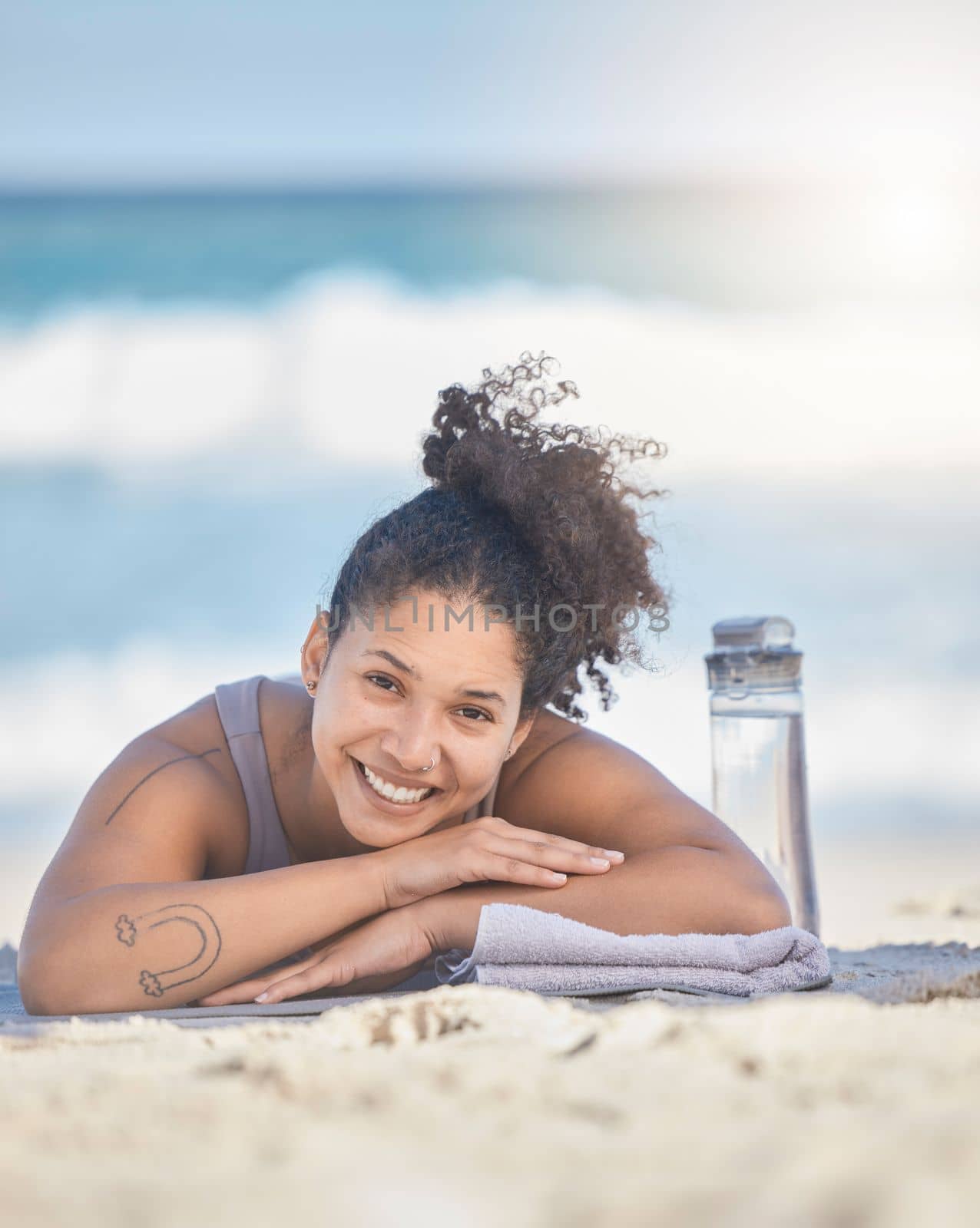Fitness, woman and relax with smile for beach, vacation or exercise for zen workout or training in the outdoors. Female relaxing and smiling after a yoga day for mental, body and spiritual wellness.