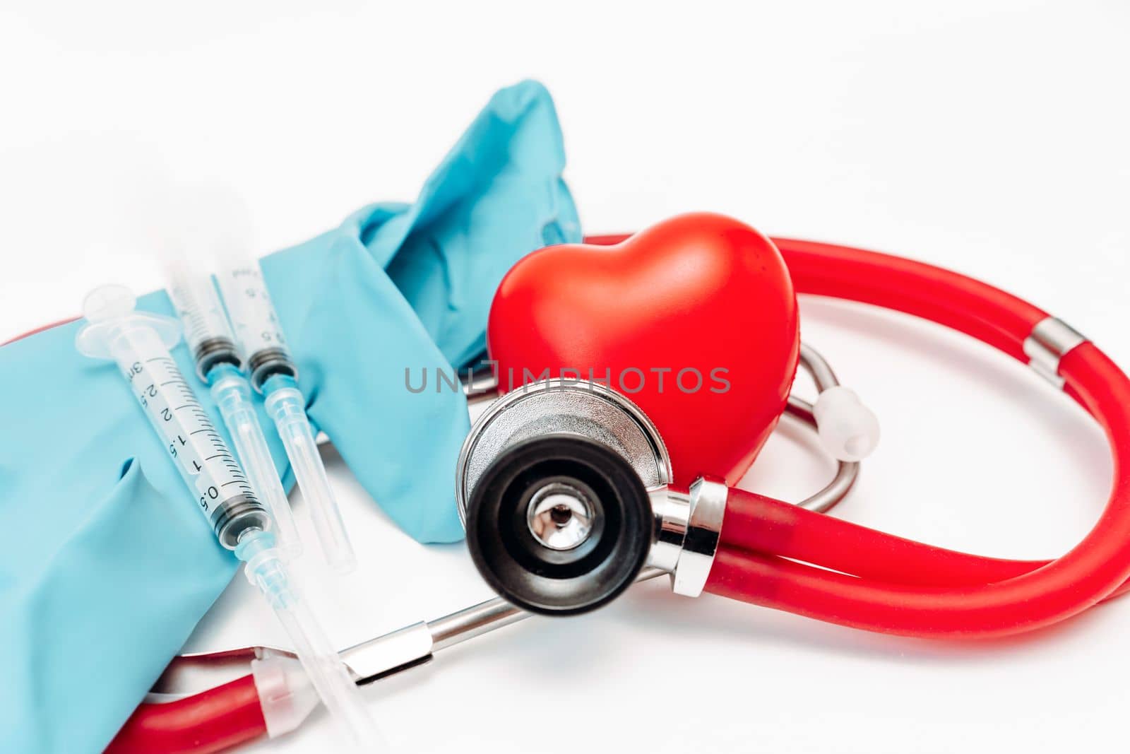 Heart stethoscope syringe. On white background, heart health, health insurance concept.