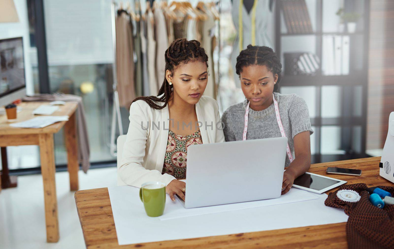 Theyre working on a new brand. two young fashion designers working on a laptop