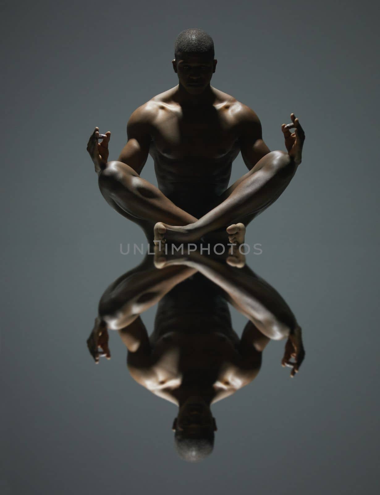 Black man, meditation and mirror reflection on dark background for spiritual wellness or symmetry. Portrait of a naked, nude or bare African American male model sitting and meditating doppelganger by YuriArcurs