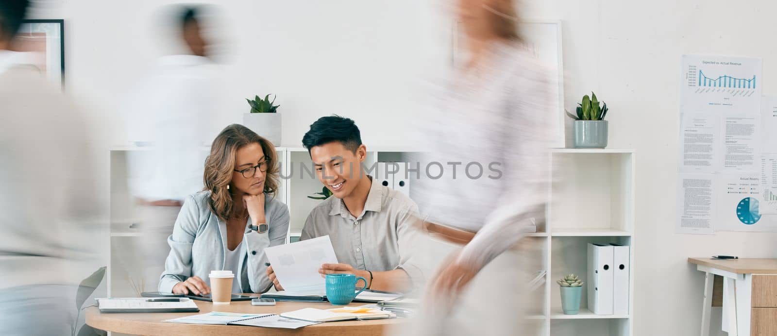 Teamwork, documents and business people in office for review or discussion. Paperwork, collaboration or Asian man and woman at desk in busy workplace planning sales, advertising or marketing strategy by YuriArcurs