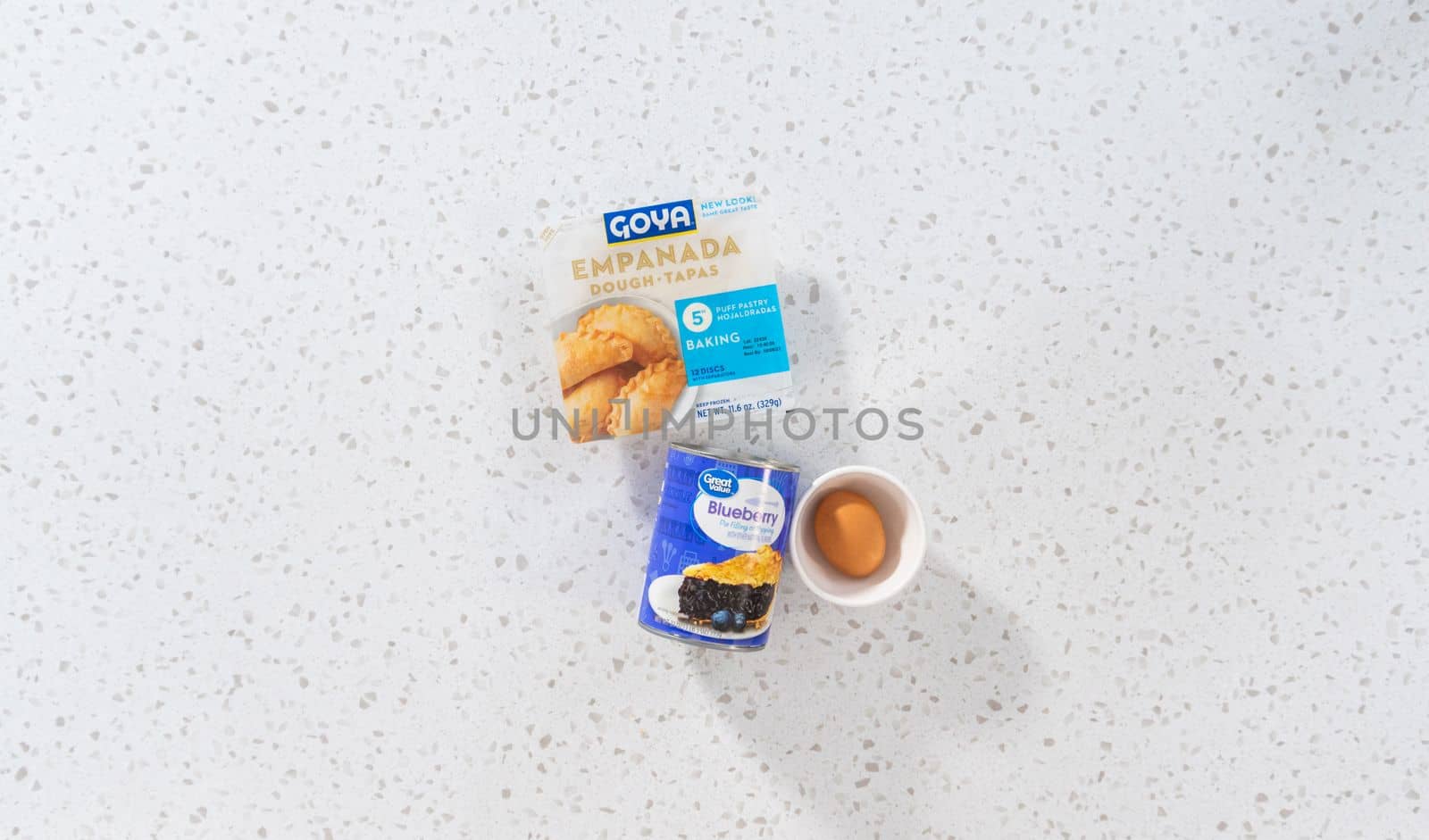 Denver, Colorado, USA-August 15, 2022-Flat lay. Measured ingredients in glass mixing bowls to make sweet empanadas with blueberries.