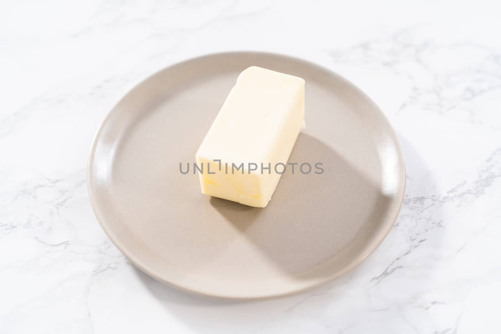 Sticks of unsalted butter on the small plates.