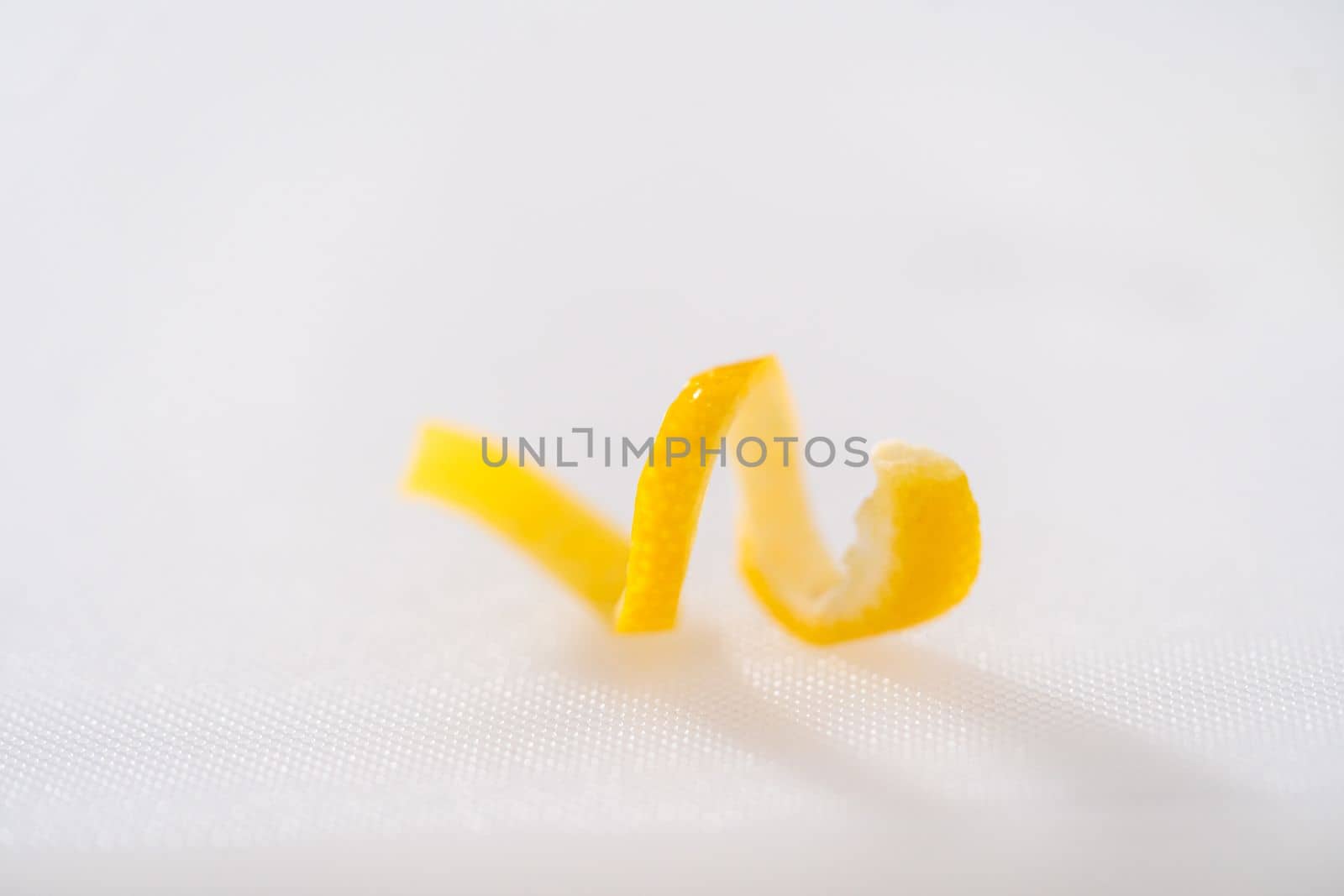 Preparing lemon swirls from the organic lemon to decorate the cocktail.