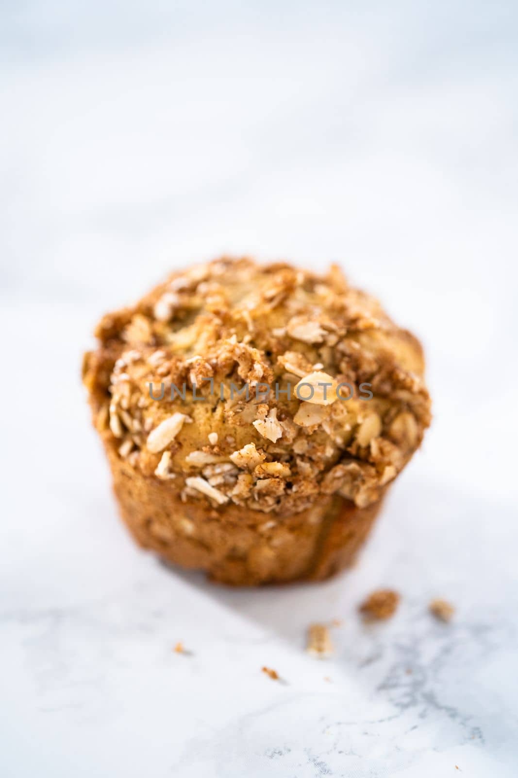 Freshly baked banana oatmeal muffins with oatmeal sugar topping.