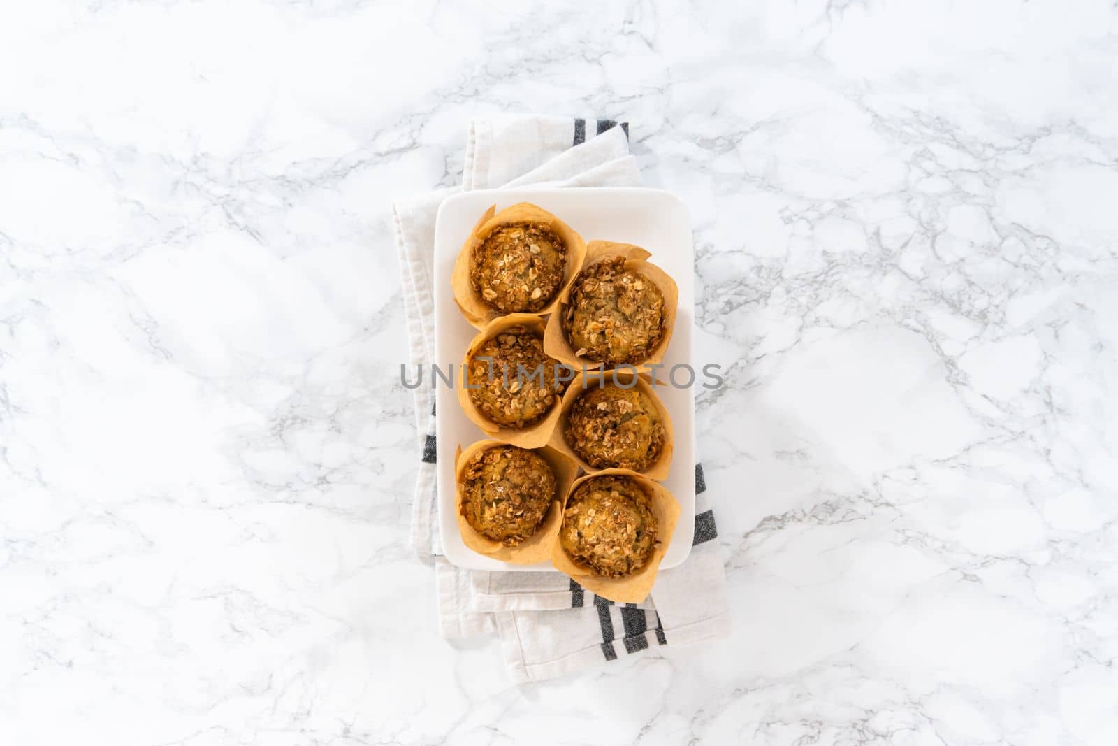 Flat lay. Freshly baked banana oatmeal muffins with oatmeal sugar topping.