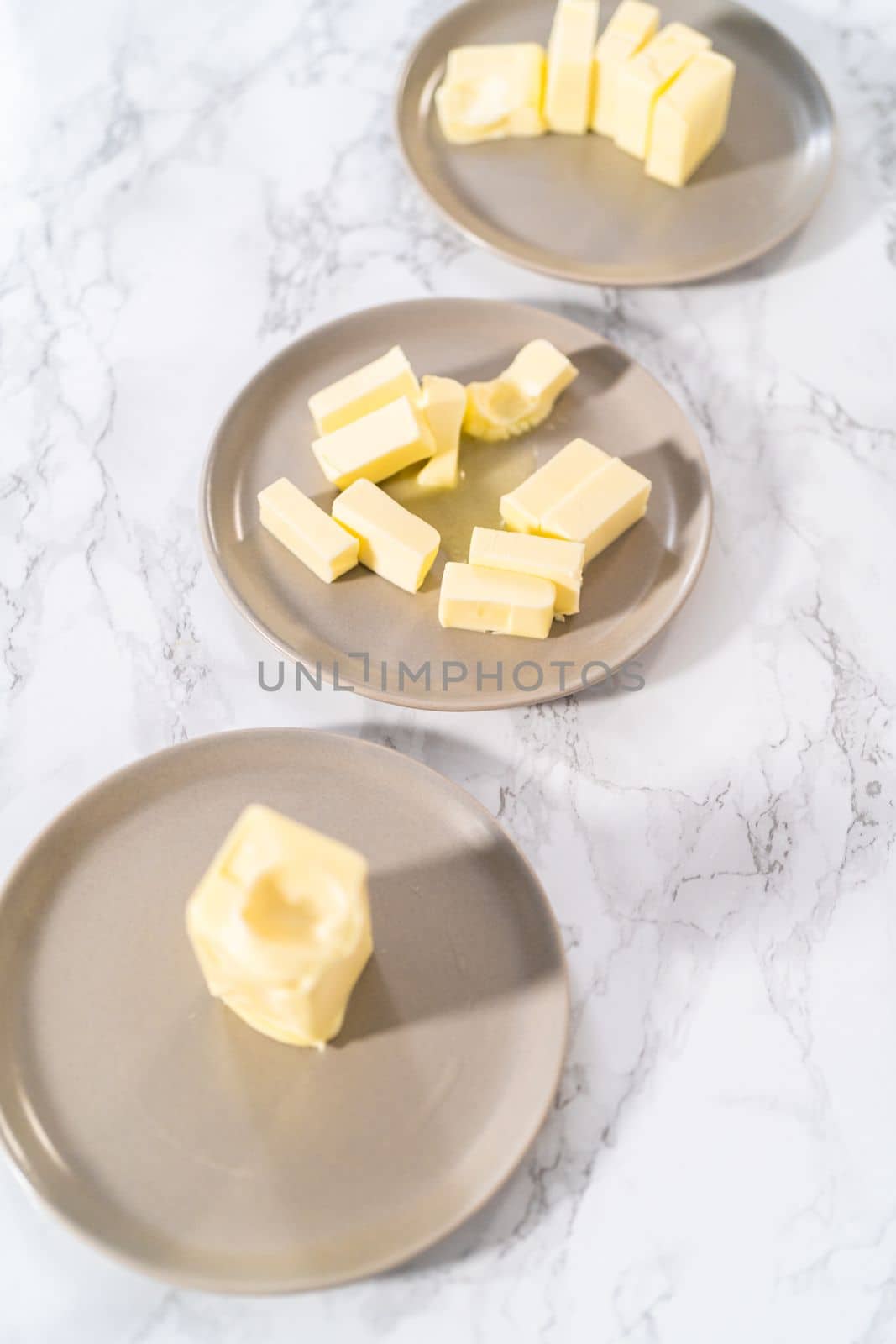 Softened sticks of unsalted butter on the counter.